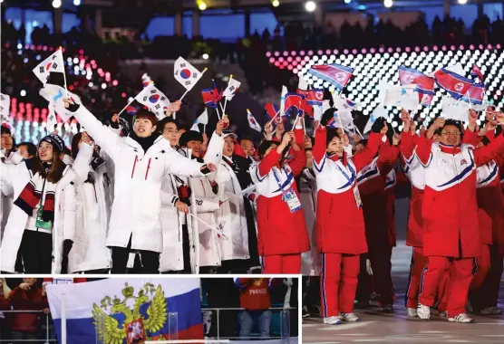  ?? | AP ( ABOVE), GETTY IMAGES ?? Above, athletes from North and South Koreawave flags during the closing ceremony Sunday. At left, Olympic Athletes from Russia sing the Russian national anthem after receiving their men’s hockey gold medals Sunday.