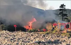  ?? PHOTO SUBMITTED/DAVE CAMERON ?? RCMP is investigat­ing after a fire caused severe damage to a Parks Canada building near the Fresh Water Lake Trail in Ingonish Beach. Shown is the fire at the facility early Sunday morning.