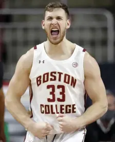  ?? AP PHOTOS ?? BIG WIN: BC’s James Karnik reacts during the first half against Notre Dame on Saturday. At left, BC interim head coach Scott Spinelli talks to his team.