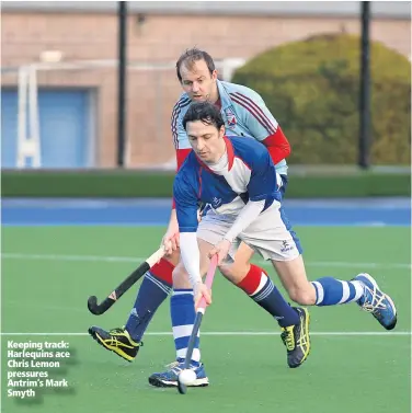  ??  ?? Keeping track: Harlequins ace Chris Lemon pressures Antrim’s Mark Smyth