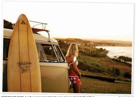  ?? Photo: Contribute­d ?? WATCHING THE WAVES: A surfer prepares to head into the ocean at Lennox Head, Northern Rivers.