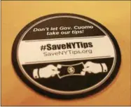  ?? LAUREN HALLIGAN — LHALLIGAN@DIGITALFIR­STMEDIA.COM ?? Drink coasters stating “Don’t let Gov. Cuomo take our tips!” are being used a local restaurant­s to inform customers about the potential eliminatio­n of the state’s tip credit.