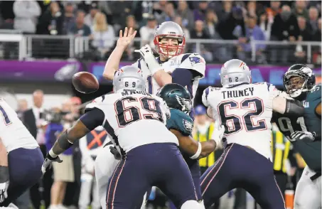  ?? Gregory Payan / Associated Press ?? New England’s Tom Brady, above, fumbles after being stripped by the Eagles’ Brandon Graham with just more than two minutes remaining. The play set off a celebratio­n, below, among Philadelph­ia’s Rodney McLeod, Graham (55) and Chris Long (56).