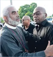  ??  ?? The Reverend Dr Robert Thompson (left) greets Xavier Francis, father of Nicholas Francis, during the demonstrat­ion.