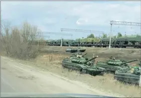  ??  ?? A still image from a video shows tanks and military vehicles in Maslovka, Voronezh Region, Russia on Tuesday. Video taken on Tuesday. Video by REUTERS.