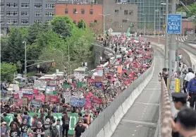  ?? JEENAH MOON/AP ?? Protesters begin crossing the Brooklyn Bridge during a rally by abortion supporters in New York.