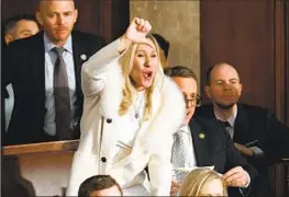  ?? Jim Watson AFP/Getty Images ?? CULTURE WARRIORS such as U.S. Rep. Marjorie Taylor Greene (R-Ga.) are part of the anti-woke crowd. Above, she protests a comment by President Biden.