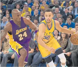  ??  ?? The Warriors’ Stephen Curry, right, dribbles against the Lakers’ Kobe Bryant.