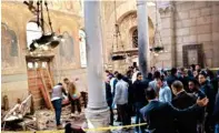  ?? AP/PTI ?? Security forces examine the scene inside St Mark Cathedral in central Cairo, following a bombing on Sunday