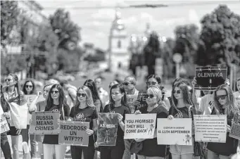  ?? David Goldman/Associated Press ?? Protesters in Kyiv, Ukraine, attend a rally Saturday for Ukrainian soldiers captured by Russia after the fall of Mariupol in May. On Friday, dozens of prisoners of war died in an attack.