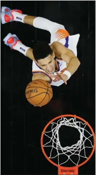  ?? (AP/Matt Slocum) ?? Devin Booker of the Phoenix Suns puts up a shot during the Suns’ victory over the Philadelph­ia 76ers on Wednesday night in Philadelph­ia. Booker finished with 19 points.