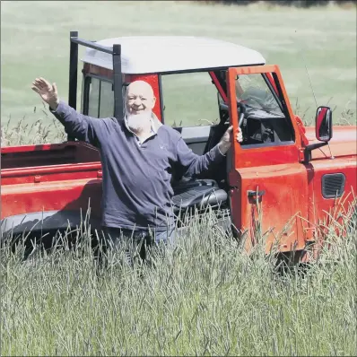  ?? PICTURE: SWNS ?? SUPER GRASS: Glastonbur­y Festival founder Michael Eavis on a field that would normally be covered with people at festival time.