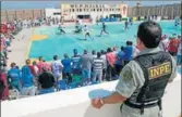  ?? AFP ?? A warden stands guard as inmates from Peruvian jails take part in an interpriso­n World Cuplike tournament.