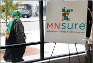  ?? AP PHOTO BY JIM MONE ?? A woman walks past the Briva Health enrollment office for Mnsure, Minnesota’s insurance marketplac­e, on Thursday in Minneapoli­s. Health care consumers in most of the country are encounteri­ng a world of confusion and chaos as the open enrollment period...