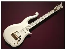  ?? (Arkansas Democrat-Gazette/Philip Martin) ?? An electric guitar is also on display at the “Crafting America” exhibition at Crystal Bridges Museum of American Art in Bentonvill­e. It is a replica — or very similar to — the iconic “Angel Cloud” white model that was featured in Prince’s 1984 movie “Purple Rain.”