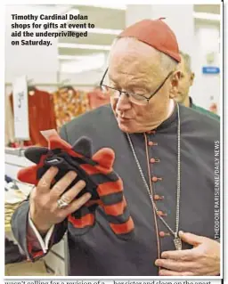  ??  ?? Timothy Cardinal Dolan shops for gifts at event to aid the underprivi­leged on Saturday.