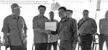  ??  ?? Ramlee handing over the Pasar Awam Sejahtera project’s warrant to the contractor.