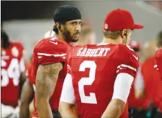  ?? Associated Press ?? San Francisco 49er quarterbac­ks Colin Kaepernick, left, and Blaine Gabbert stand on the sideline during an NFL preseason football game against the Green Bay Packers on Friday, in Santa Clara.