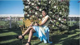  ??  ?? SEASON’S GREETINGS. Horseracin­g fan Given Nefotoni poses for a picture at the Turffontei­n Racecourse on Saturday.