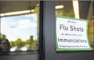  ?? Brian A. Pounds / Hearst Connecticu­t Media file photo ?? A sign on the front door advertises flu shots at the Walgreens on Barnum Avenue in Stratford on Sept. 22, 2014.