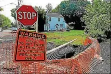  ?? FREEMAN FILE PHOTO ?? The Washington Avenue sinkhole in Kingston has kept several blocks of the road closed to traffic since the spring of 2011.