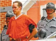  ?? ASSOCIATED PRESS FILE PHOTO ?? Eric Frein is escorted by police on Oct. 31, 2014, into the Pike County Courthouse for his arraignmen­t in Milford, Pa. Frein, a survivalis­t who eluded capture for 48 days after allegedly killing a trooper and wounding Alex Douglass in an ambush, says...