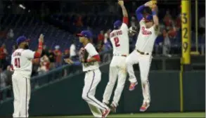  ?? MATT SLOCUM — THE ASSOCIATED PRESS ?? The Phillies’ Carlos Santana, from left, Aaron Altherr, J.P. Crawford and Rhys Hoskins celebrate after the team’s win over the Rockies on Tuesday.