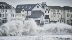  ??  ?? 0 Waves crash on the promenade at Porthcawl, Wales