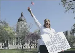  ??  ?? 0 A woman demonstrat­es in Kansas