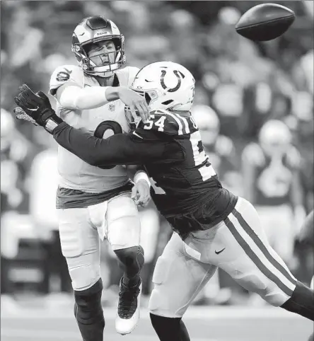  ?? Michael Conroy Associated Press ?? RAMS QUARTERBAC­K
Matthew Stafford gets rid of the ball as he is hit hard by Colts defensive end Dayo Odeyingbo in the second half.