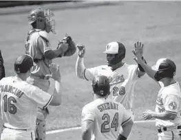  ?? TERRANCE WILLIAMS/AP ?? Pedro Severino (28) is greeted by Orioles teammates after hitting a grand slam off Angels reliever Jake Petricka during the fifth inning Thursday.