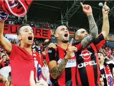  ?? (Eran Luf) ?? HAPOEL HAIFA captain Hanan Maman (center) celebrates with the fans in the stands, a scene which has been repeated time and again so far this season, with Haifa’s unheralded squad setting the early pace in the Premier League.