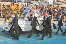  ?? Reuters ?? Cheered by a multitude of faithful, Pope Francis arrives at the stadium at Arbil in his open-sided popemobile.
