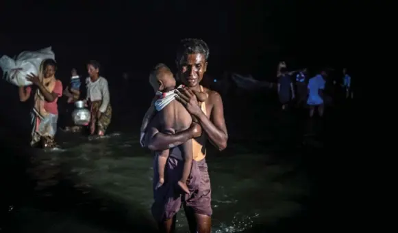  ?? SERGEY PONOMAREV PHOTOS/THE NEW YORK TIMES ?? Rohingya refugees from Burma arrive in Bangladesh after crossing the Naf River. UN officials have called the campaign against the Rohingya in Burma a “textbook example” of ethnic cleansing.