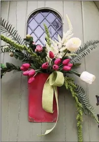  ??  ?? This rustic red tin is filled with green linen ribbon, amaranths stem, real touch Boston fern, white peony bud bunch, pink peony bud bunch, white astilbe stem, fuchsia tulip bunch, large white tulips (can substitute tulips for white peony stems as well). (TNS/Nell Hills)