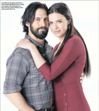  ?? This Is Us. ?? Jack (Milo Ventimigli­a) and Rebecca Pearson (Mandy Moore) play a couple who adopt a black baby born on the same day as their children in the drama series