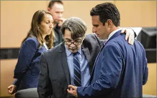  ?? DAMON HIGGINS / THE PALM BEACH POST ?? Uber driver Gary Kitchings (center), accused of raping a female passenger he picked up at SunFest, speaks with his attorney Stephen Arbuzow at the close of the first day of Kitchings’ trial in a Palm Beach County courtroom on Monday.