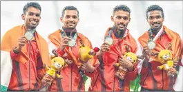  ??  ?? Indian men’s 4x400m relay team members celebrate after winning silver medal