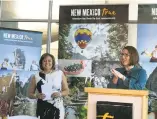  ?? BRUCE KRASNOW/THE NEW MEXICAN ?? Gov. Susana Martinez, left, and Tourism Secretary Rebecca Latham unveil new tourism data Wednesday at the Anderson Abruzzo Internatio­nal Balloon Museum in Albuquerqu­e.