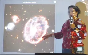  ?? Westside Eagle Observer/SUSAN HOLLAND ?? Katherine Auld, a NASA Solar System Ambassador and founder of NWA Space, explains images from the Cartwheel Galaxy during a NASA @ My Library program Thursday evening, August 25, at the Gravette Civic Center. The program, hosted by the Gravette Public Library, featured several of the first images sent back from the James Webb Space Telescope which was launched in late December.