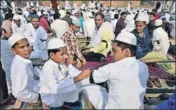  ??  ?? Villagers tie black armbands as a mark of protest against the killing of 16yearold Junaid.