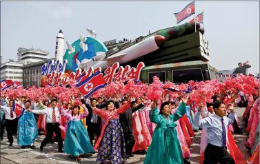  ?? REUTERS ?? People react as they march past the stand with North Korean leader Kim Jong Un during a military parade marking the 105th birth anniversar­y of the country’s founding father Kim Il Sung, in Pyongyang, on Saturday.