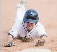  ?? LIAM RICHARDS/The StarPhoeni­x ?? Team Saskatchew­an’s Jordan Malainey dives to third base
against Team New Brunswick on Sunday.