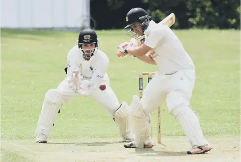  ??  ?? Mark Hodgson on his way to 40 for Oundle against Peterborou­gh Town. Town’s wicket-keeper is Chris Milner.