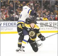  ?? Bruce Bennett / Getty Images ?? The Bruins’ Torey Krug mixes it up with the Blues’ David Perron during the third period in Game 1 of the Stanley Cup Finals on Monday in Boston.