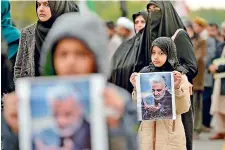  ??  ?? Protesters carry posters with the image of top Iranian commander Qasem Soleimani, who was killed in a US airstrike in Iraq, during a demonstrat­ion in Islamabad on Friday. AFP