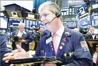  ??  ?? Trader John Panin works on the floor of the New York Stock Exchange, on July 30. Stocks are off to a mixed start
on Wall Street as gains in banks and energy companies are offset by losses in other sectors, (AP)