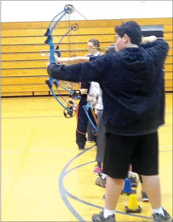  ?? SALLY CARROLL/MCDONALD COUNTY PRESS ?? Thirteen-year-old Scott McCool pulls back his bow during White Rock Archery practice. McCool says archery provides an outlet that reduces the stress of homework.