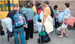  ?? AFP ?? People line up to enter a hurricane shelter at Trask Middle School in wilmington, North Carolina. Hurricane would deliver a ‘direct hit’ to the US East Coast. —