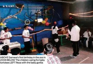  ??  ?? ABOVE Samara’s first birthday in the zoo in 2008 BELOW The children caring for baby tortoises LEFT Reza with the baby gorilla